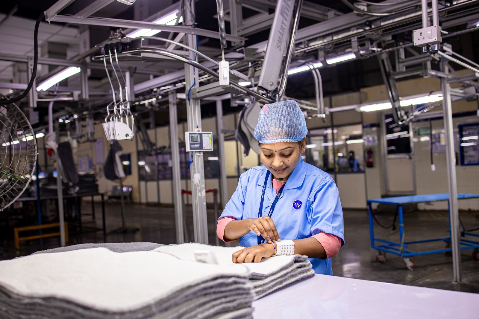 Garment production floor — finished apparel being folded and checked